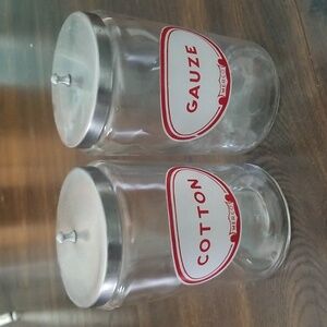 Pair of vintage apothecary jars, cotton and gauze from medical practice.